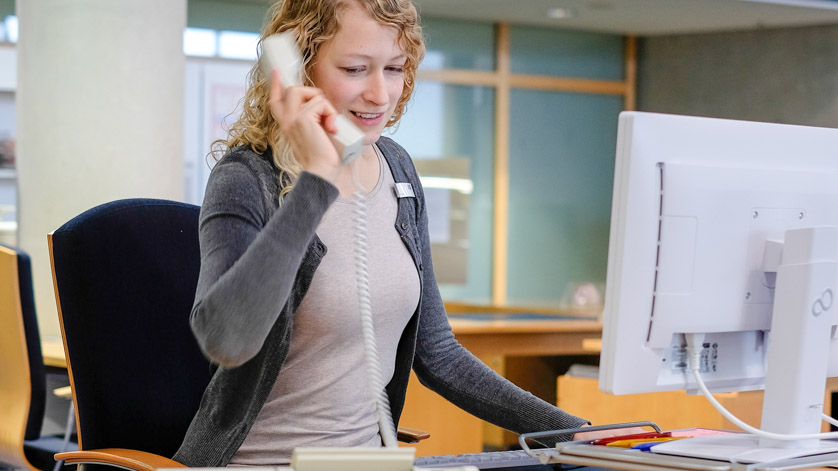 Eine Mitarbeiterin der Deutschen Nationalbibliothek nimmt ein Telefonat entgegen.