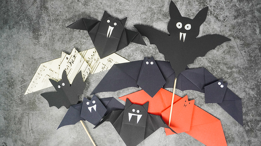 Bats made of paper on a grey background