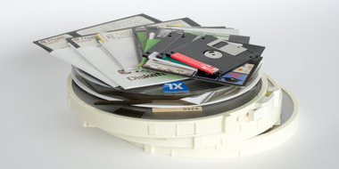 Magnetic tapes, floppy disks in various sizes and optical data carriers in a pile